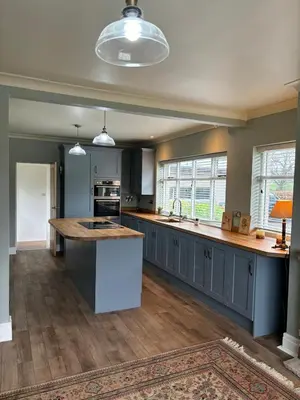 a large kitchen with blue cabinets and a large island at Oaken Fields, Waddington, Clitheroe in Waddington