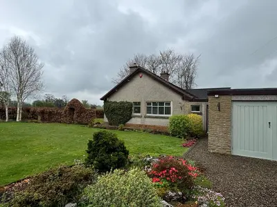 a house with a garage and a grass yard at Oaken Fields, Waddington, Clitheroe in Waddington