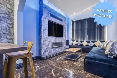 a living room with a couch and a tv at New Mixies Manor in Blackpool