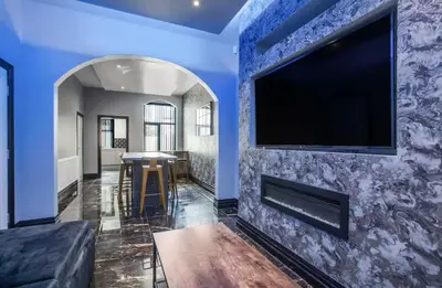 a living room with a tv on a blue wall at New Mixies Manor in Blackpool