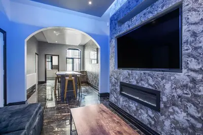 a living room with a flat screen tv on a blue wall at New Mixies Manor in Blackpool