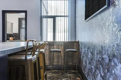 a bar with two stools at a counter in a room at New Mixies Manor in Blackpool