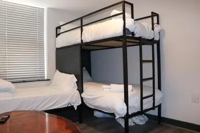 two bunk beds in a room with a table at 80 Anfield house in Liverpool