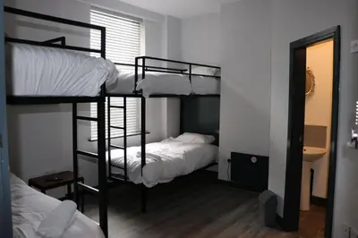 two bunk beds in a room with a mirror at 80 Anfield house in Liverpool