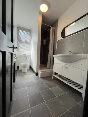 a bathroom with a white tub and a toilet at 80 Anfield house in Liverpool