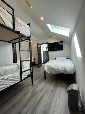a room with two bunk beds and a ceiling at 80 Anfield house in Liverpool