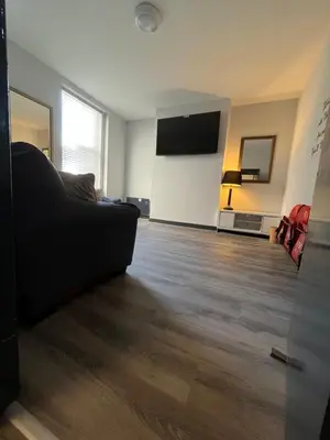 a living room with a couch and a flat screen tv at 80 Anfield house in Liverpool