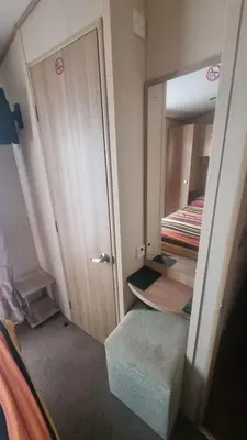 a small room with a door and a mirror at Private Caravan to Hire - Marton Mere Haven Holiday Village in Blackpool