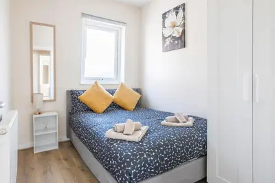 a bedroom with a bed with two pillows on it at Free Parking, 4 Bed, 2 Bath House, Long Term Stay Savings, Contractors, Near Anfield in Liverpool