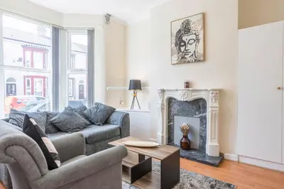 a living room with a couch and a fireplace at Free Parking, 4 Bed, 2 Bath House, Long Term Stay Savings, Contractors, Near Anfield in Liverpool