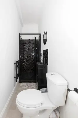 a white bathroom with a toilet and a shower at Free Parking, 4 Bed, 2 Bath House, Long Term Stay Savings, Contractors, Near Anfield in Liverpool