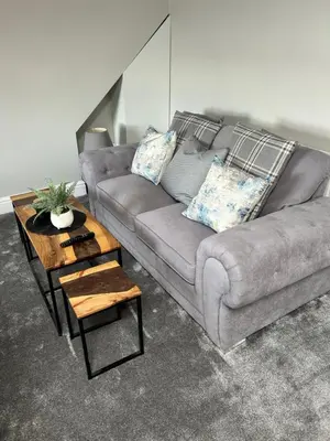 a living room with a couch and a coffee table at Sunny St Annes Apartment in Lytham St Annes
