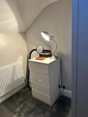 a lamp on top of a dresser in a room at Sunny St Annes Apartment in Lytham St Annes
