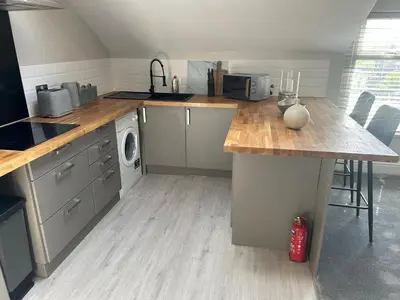 a kitchen with a wooden counter top in a room at Sunny St Annes Apartment in Lytham St Annes