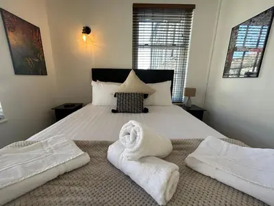 a bedroom with a bed with towels on it at The Hideaway - 2-Bedroom Apartment with outdoor terrace & free parking in Lancaster