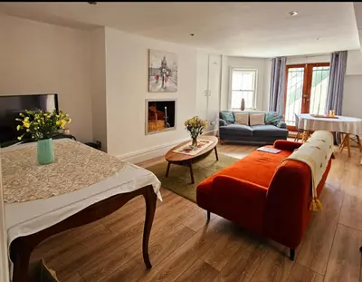 a bedroom with a bed and a living room at Liverpool Georgian Quarter Apartment in Liverpool