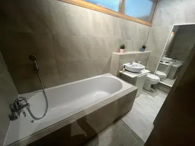 a bathroom with a bath tub and a toilet at 2 bed apartment Liverpool city centre in Liverpool