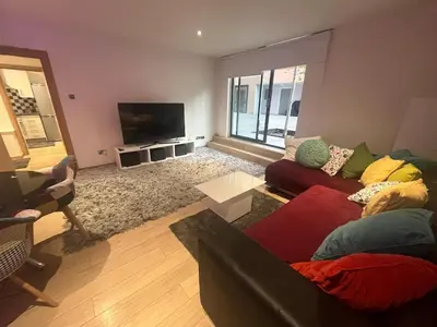 a living room with a couch and a tv at 2 bed apartment Liverpool city centre in Liverpool