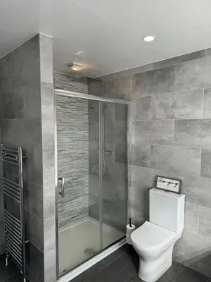 a bathroom with a toilet and a shower at Beachside Home-Pizza Oven & Bar Close To Beach and Town in Cleveleys