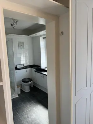 a small bathroom with a toilet and a window at Beachside Home-Pizza Oven & Bar Close To Beach and Town in Cleveleys