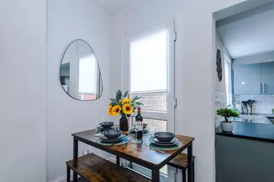 a room with a table with flowers and a mirror at Stylish 3-Bed Home in Liverpool by 53 Degrees Property, Ideal Great for Large Groups & Business, Sleeps 8! in Liverpool