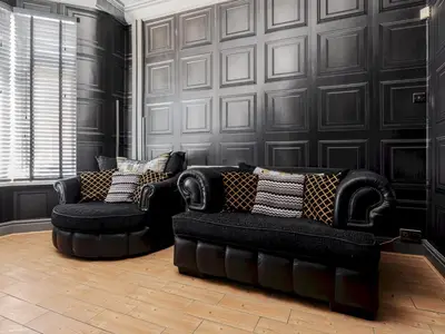 two black chairs and a couch in a room at Liverpool, Anfield 3 Bed Home, Parking & Wifi - Pass the Keys in Liverpool