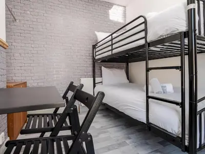 a room with two bunk beds and a desk and a chair at Liverpool, Anfield 3 Bed Home, Parking & Wifi - Pass the Keys in Liverpool