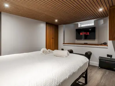 a bedroom with a bed with a tv on the wall at Liverpool, Anfield 3 Bed Home, Parking & Wifi - Pass the Keys in Liverpool