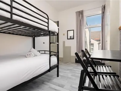 a bedroom with two bunk beds and a desk at Liverpool, Anfield 3 Bed Home, Parking & Wifi - Pass the Keys in Liverpool