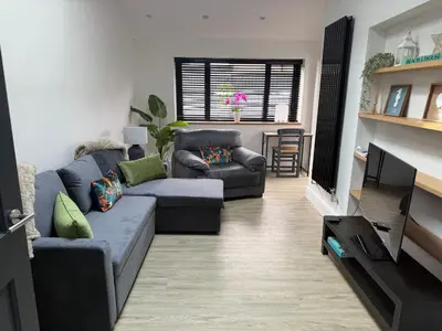 a living room with a couch and a tv at Birkdale Links Lodge in Southport