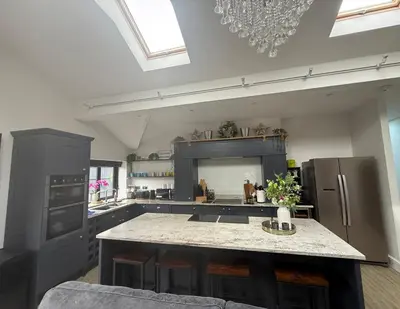a large kitchen with a island in the middle at Birkdale Links Lodge in Southport