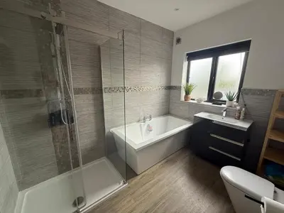 a bathroom with a tub and a shower and a sink at Birkdale Links Lodge in Southport
