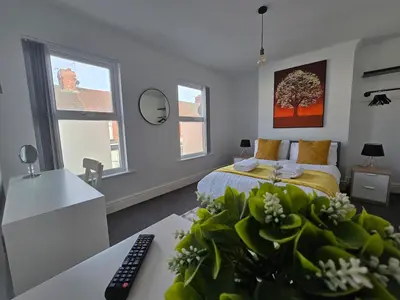 a bedroom with a bed and a desk with a computer at Cozy Home in Liverpool in Liverpool