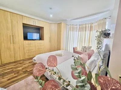 a living room with a table and a tv at Room 4 Shared House in Bootle in Litherland