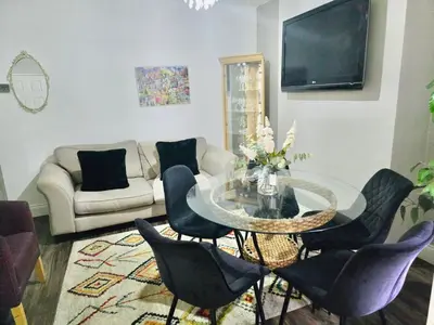 a living room with a glass table and chairs at Room 4 Shared House in Bootle in Litherland
