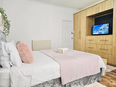 a bedroom with a bed and a tv on a wall at Room 4 Shared House in Bootle in Litherland