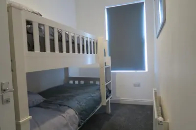 a bedroom with a bunk bed next to a window at NEW 4 Bed house close to train station and town in Blackpool