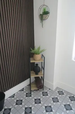 a room with black vertical blinds and a table with a plant at NEW 4 Bed house close to train station and town in Blackpool