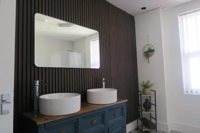 a bathroom with a sink and a mirror at NEW 4 Bed house close to train station and town in Blackpool