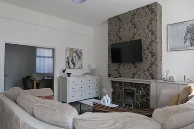 a living room with two couches and a fireplace at NEW 4 Bed house close to train station and town in Blackpool