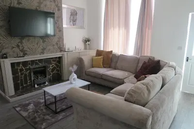 a living room with a couch and a fireplace at NEW 4 Bed house close to train station and town in Blackpool