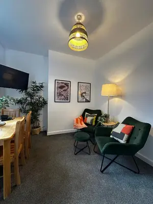 a living room with a table and chairs and a dining room at Wigan 1BR Haven - Perfect for a Relaxing Stay in Wigan