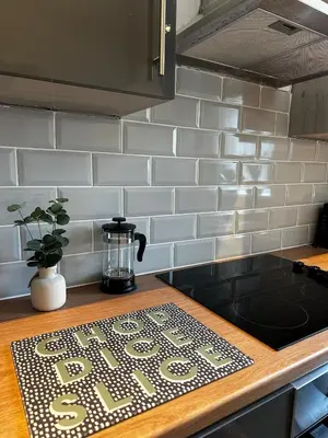a kitchen counter with a sign on a counter top at Wigan 1BR Haven - Perfect for a Relaxing Stay in Wigan