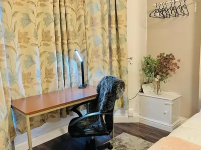a desk with a computer in a room at Cozy Home in Bootle in Liverpool