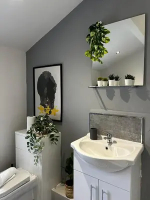 a bathroom with a sink and a mirror at Ideal Wigan Base - 1BR for Cosy Stays in Wigan