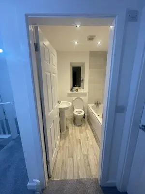 a bathroom with a toilet and a tub and a sink at blackburn home in Blackburn