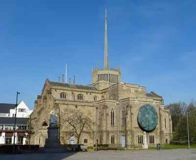 an old stone building with a statue in front of it at blackburn home in Blackburn