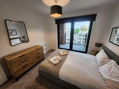 a bedroom with a large bed and a large window at Modern & Bright 2 Bedroom Apartment in Liverpool in Liverpool
