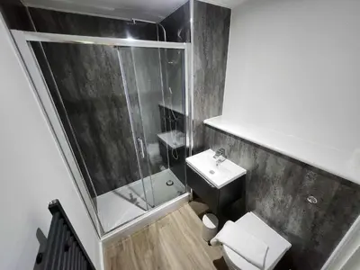 a bathroom with a shower and a toilet and a sink at Modern & Bright 2 Bedroom Apartment in Liverpool in Liverpool