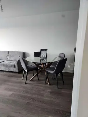 a dining room with a table with chairs and a laptop at Modern & Bright 2 Bedroom Apartment in Liverpool in Liverpool